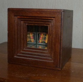 Cube en bois de 10cm de côté contenant en son fond une bibliothèque de 40 minis-livres
